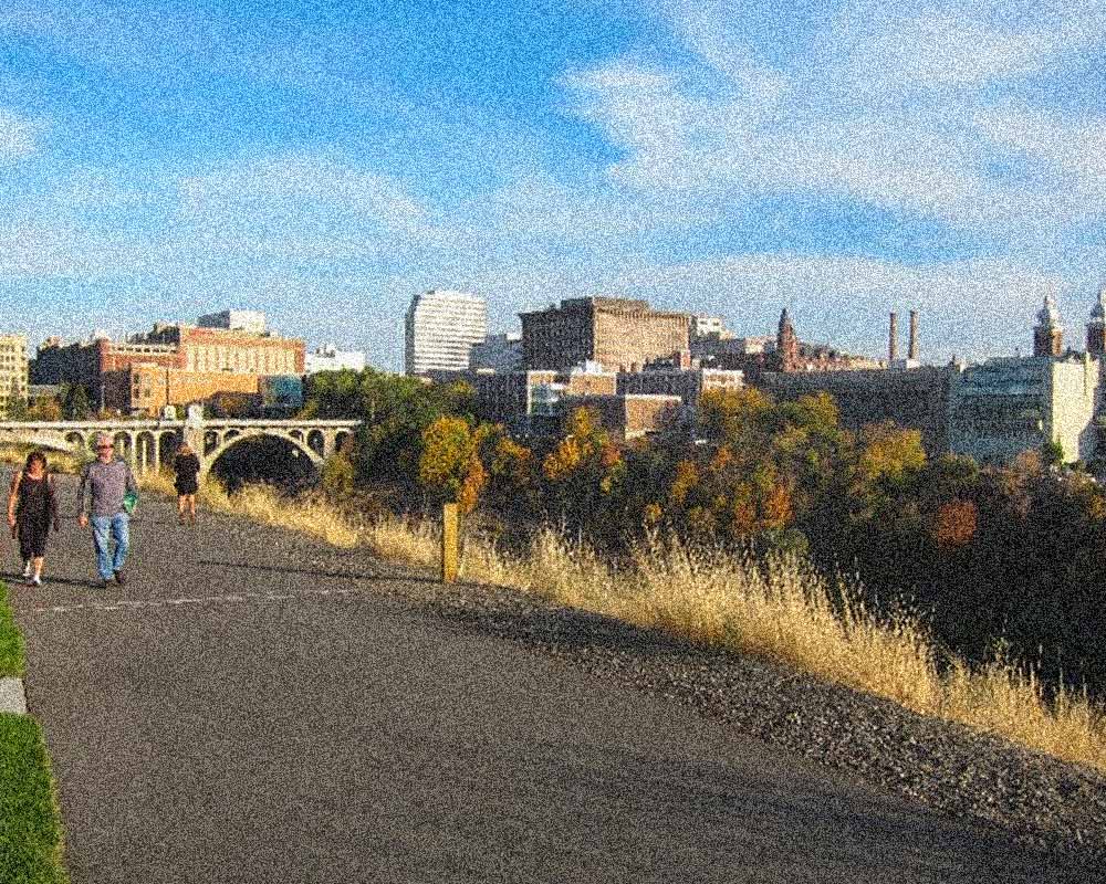 a couple walks along the trail in front of Spokane